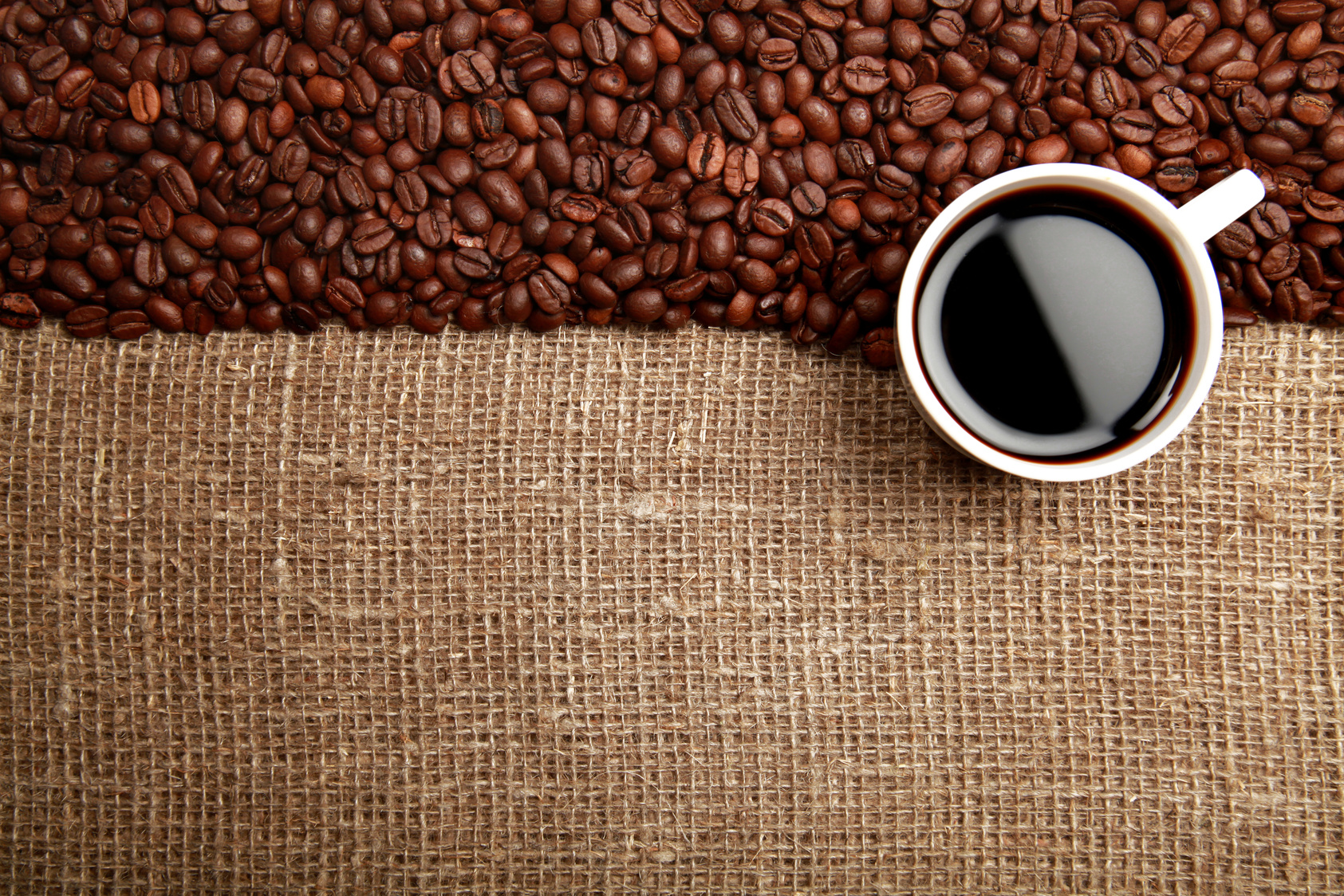 Coffee Beans And Cup Of Coffee On Burlap